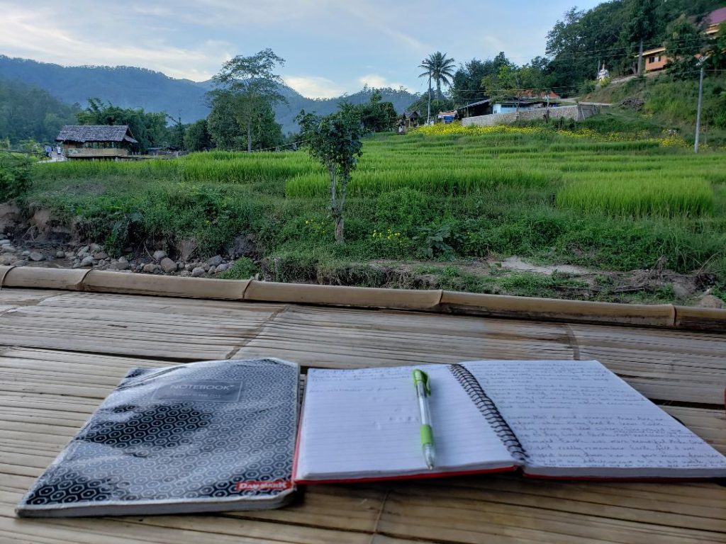 Journal writing at bamboo bridge in Thailand