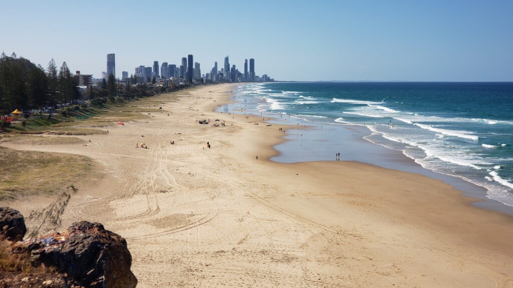 Gold Coast, with skyscrapers on one side of beach and ocean on other